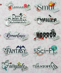 A sheet of die-cut sticker labels featuring various romance, thriller, fantasy, horror, and dystopian themes, arranged on a light pink patterned background.